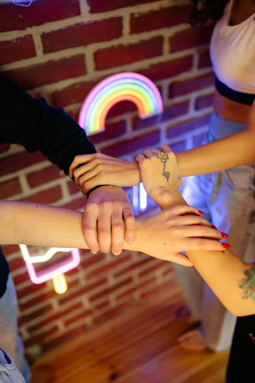 a group of young people standing in a circle holding hands