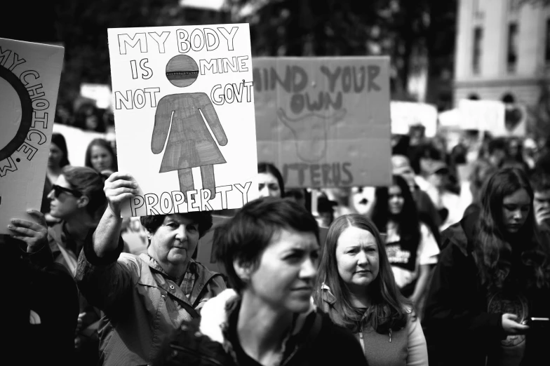 a large group of people holding signs