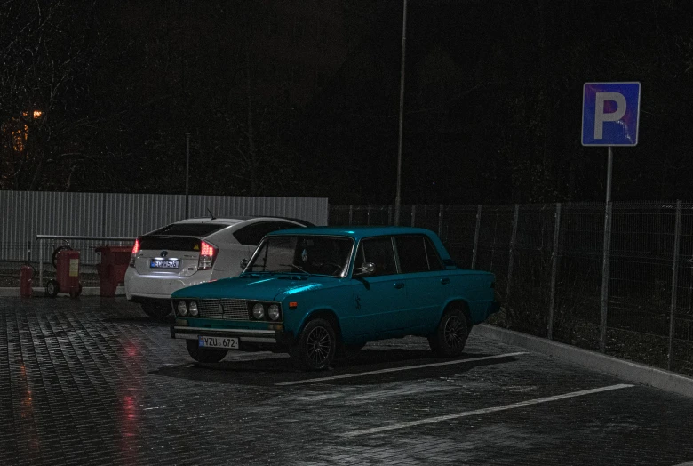 two vehicles parked in a lot on the street