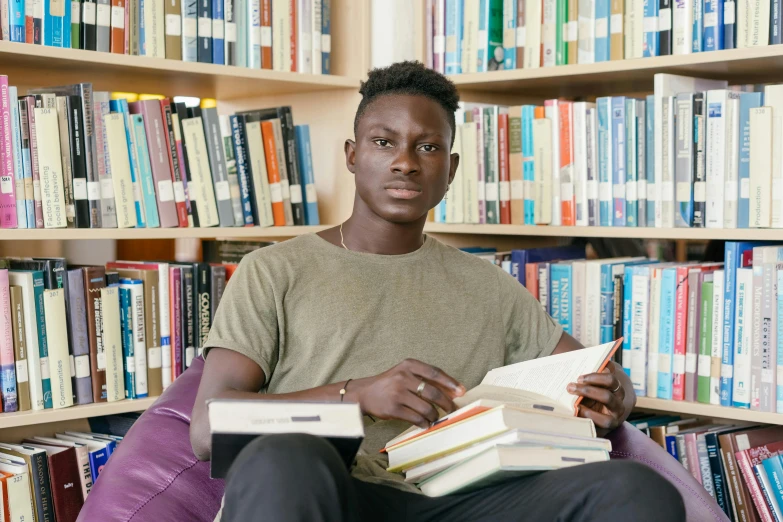 a man sitting in front of bookshelves