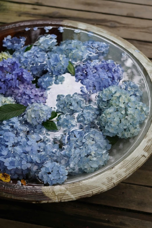 a bowl filled with flowers on top of a table