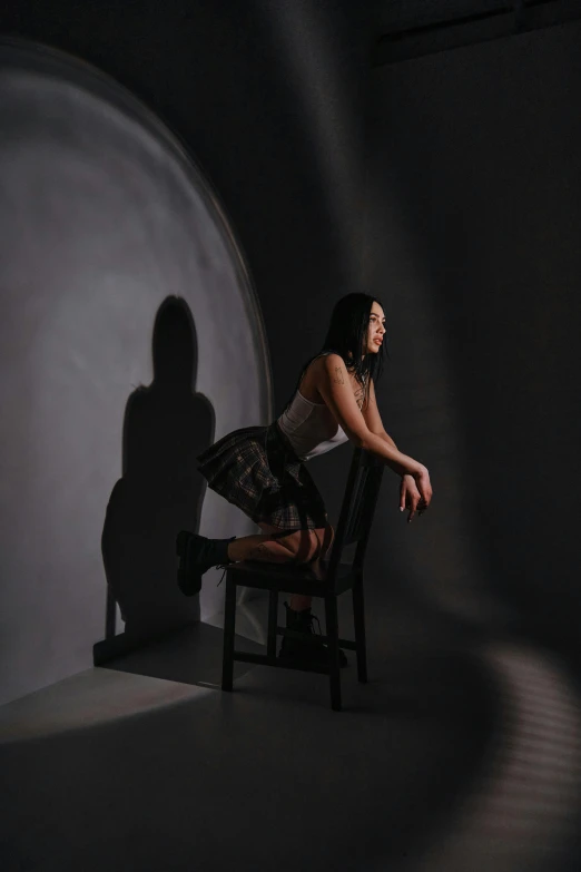 a person is sitting on a chair in the dark