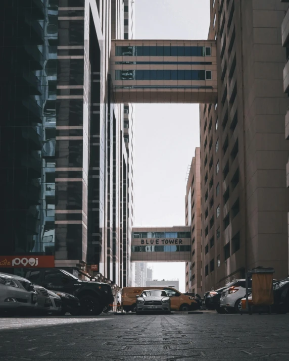 a street with buildings in a city, with a street car in front