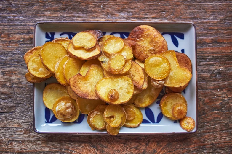 the dish is full of cooked, peeled potato wedges