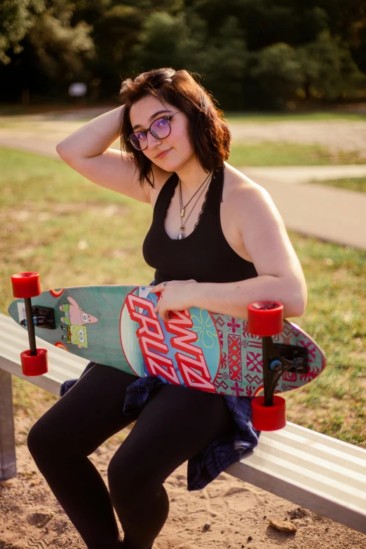 a woman is sitting on a bench holding a skateboard