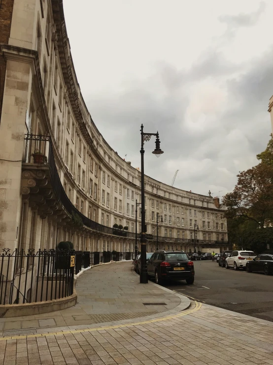 a city street with a tall building in the background