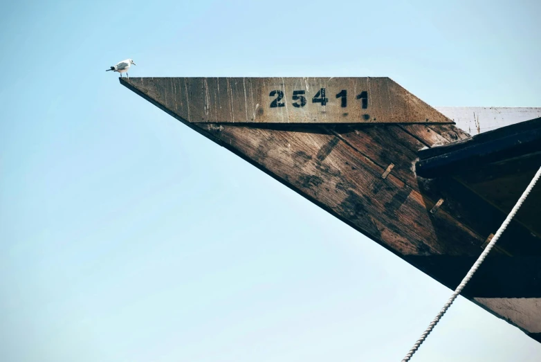 a sign at the side of a wooden structure