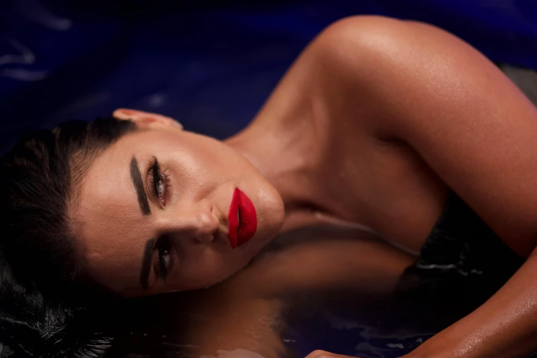 a woman with long black hair in the bath