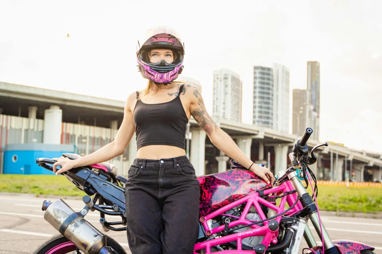 a woman with pink paint on her body and her bike