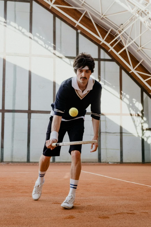 man on court with tennis racket about to hit ball