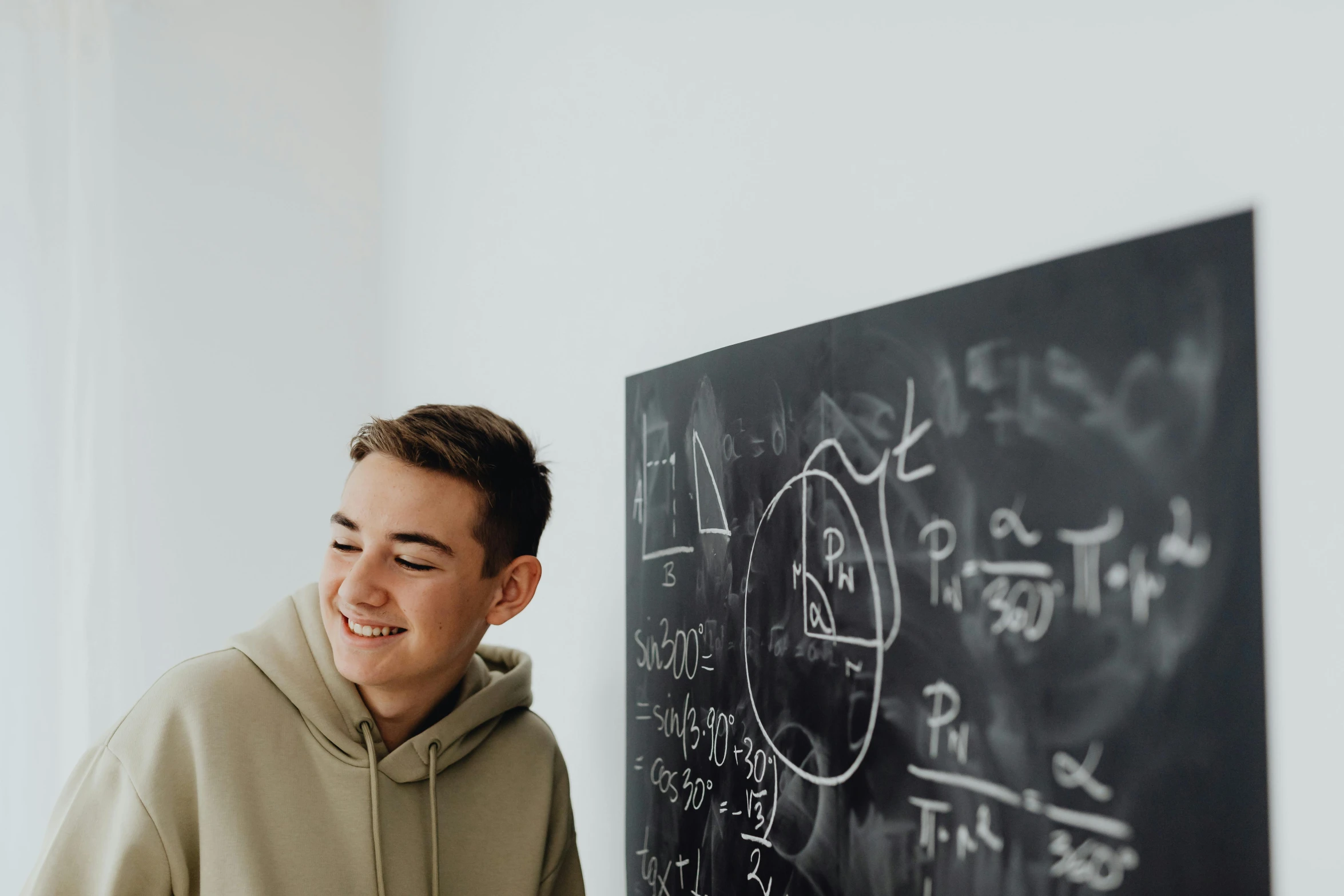 the  smiles in front of the blackboard