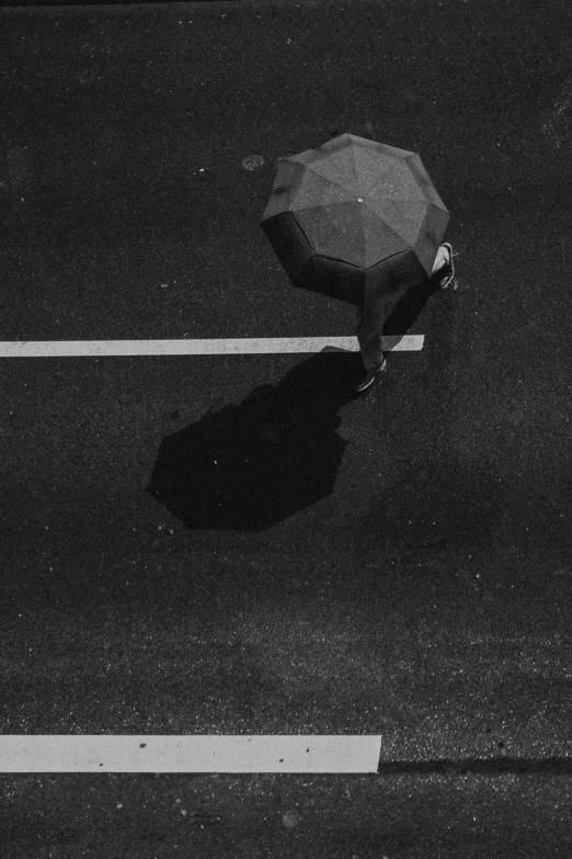 a person walking down the street holding an umbrella
