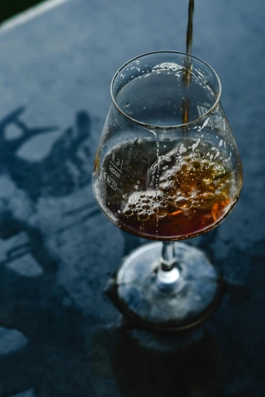 the liquid is being poured into a wine glass