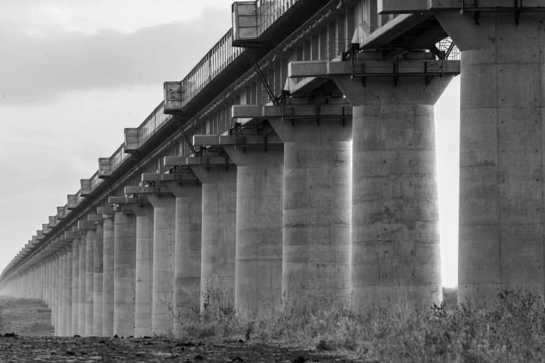 large stone pillars in an overpass next to ocean