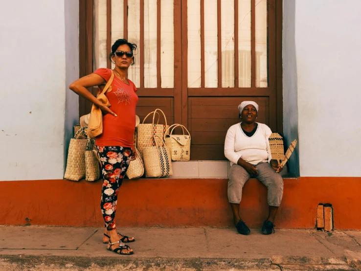 two people sitting on a bench, and a window in front of them