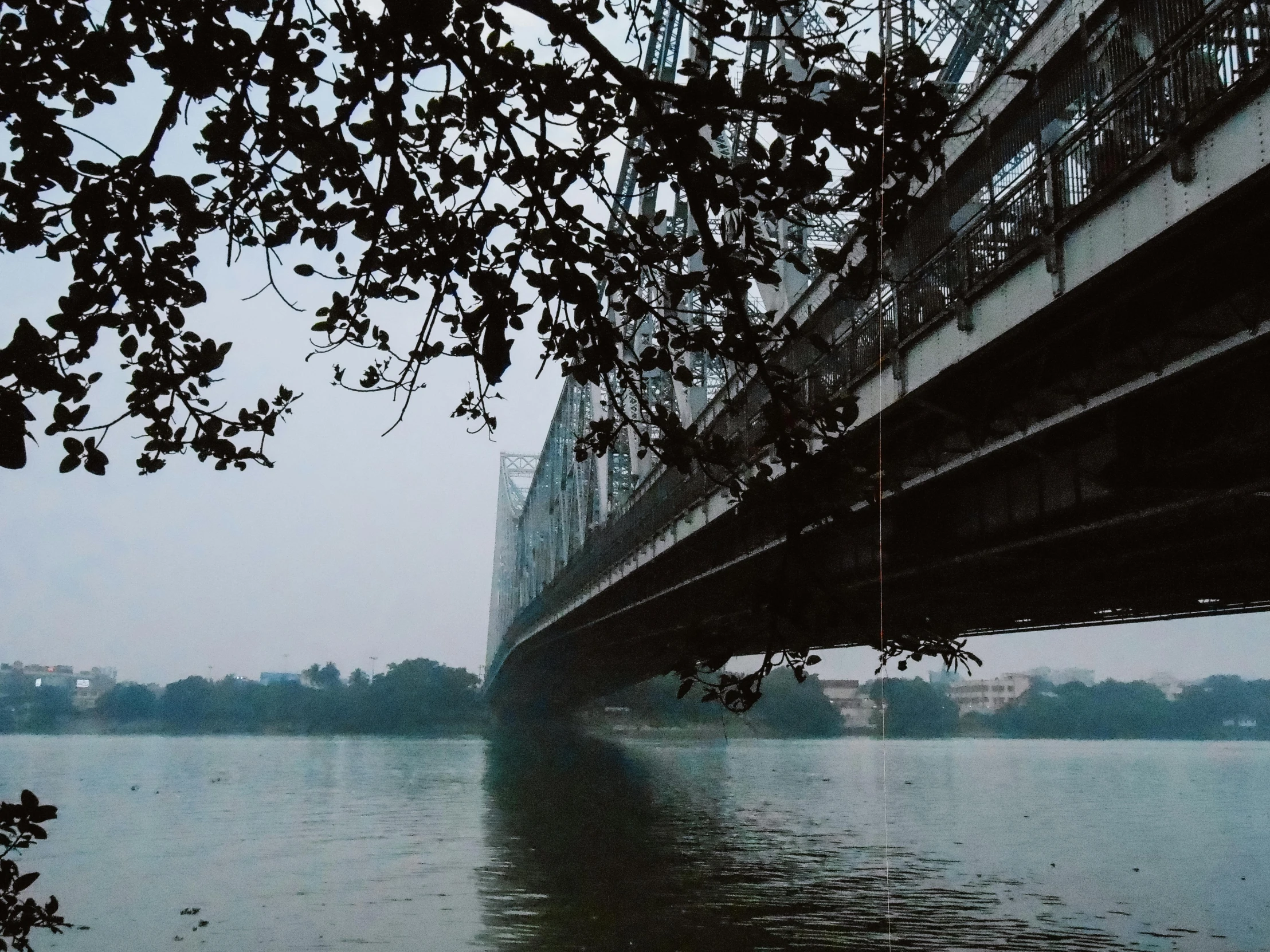 the view of water with a bridge that spans it