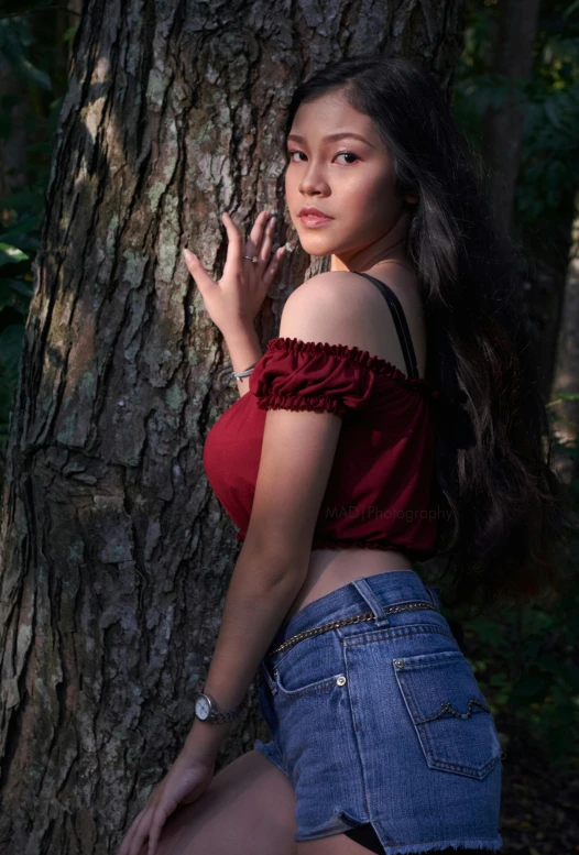 girl with  next to a tree