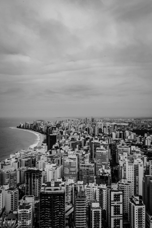 a large city with tall buildings next to a body of water