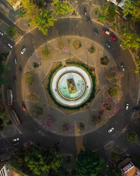 a round fountain in the center of an urban area