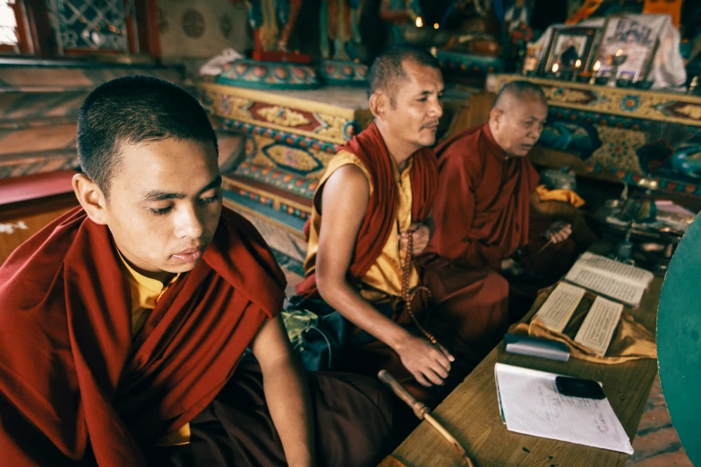two monks are sitting down on their own