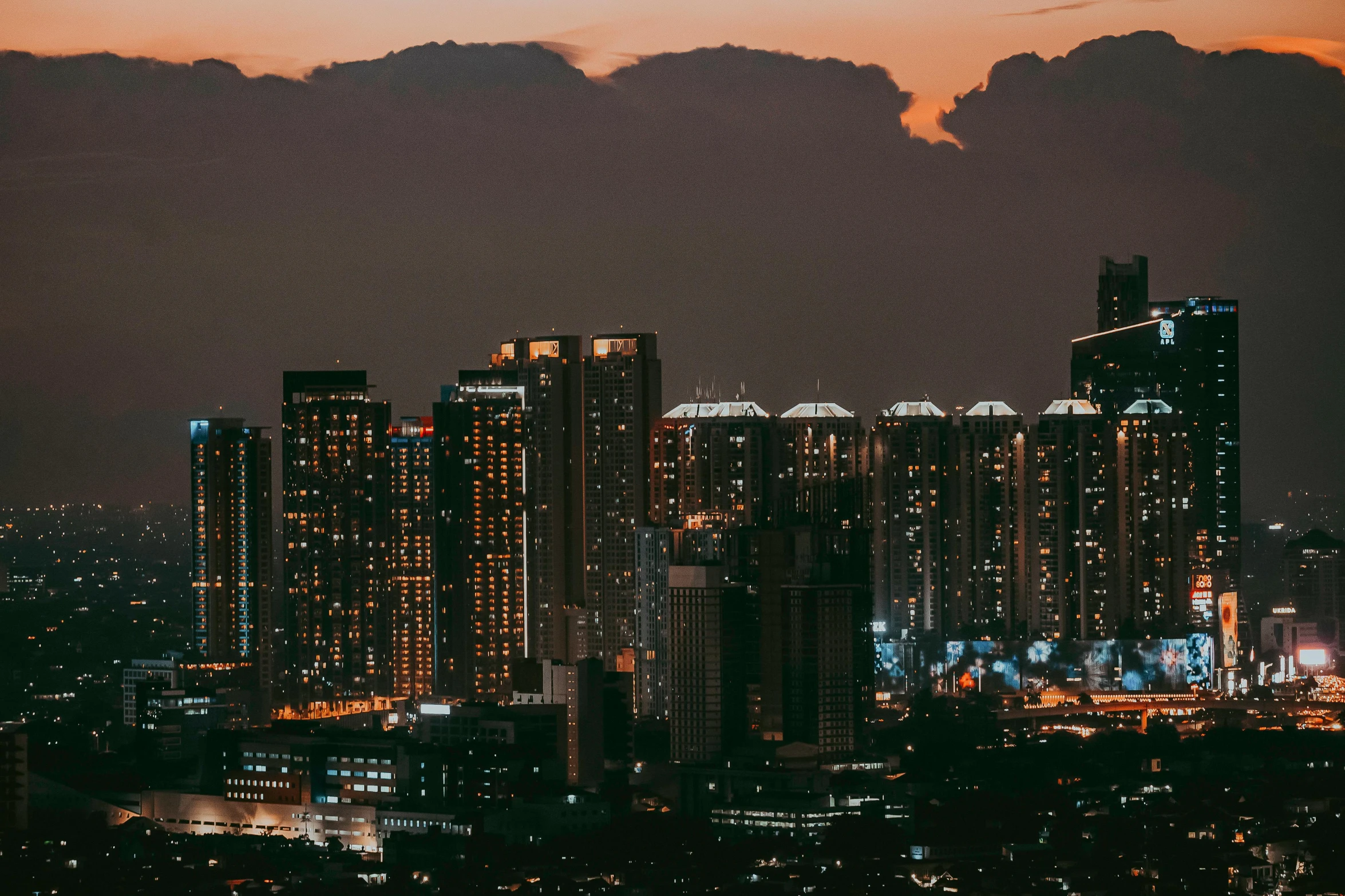 a night time view of skyscrs and city lights