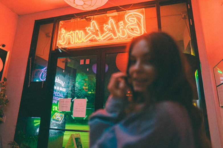 a person standing in front of a bar talking on the phone