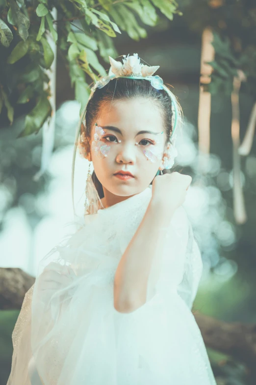  wearing a wedding dress and with large flower in hair