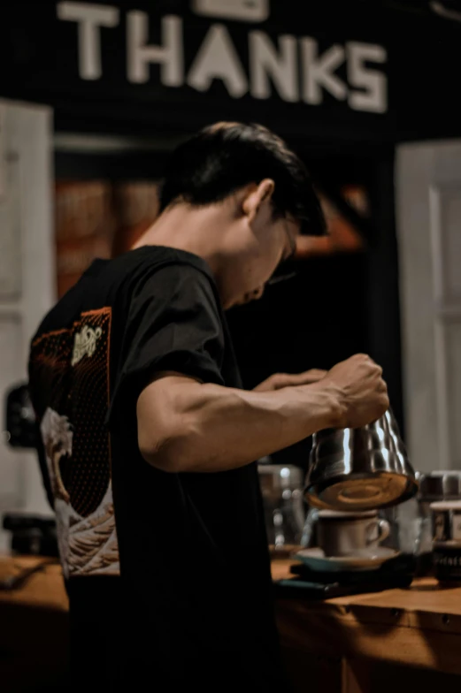 the man is stirring a cup on the coffee