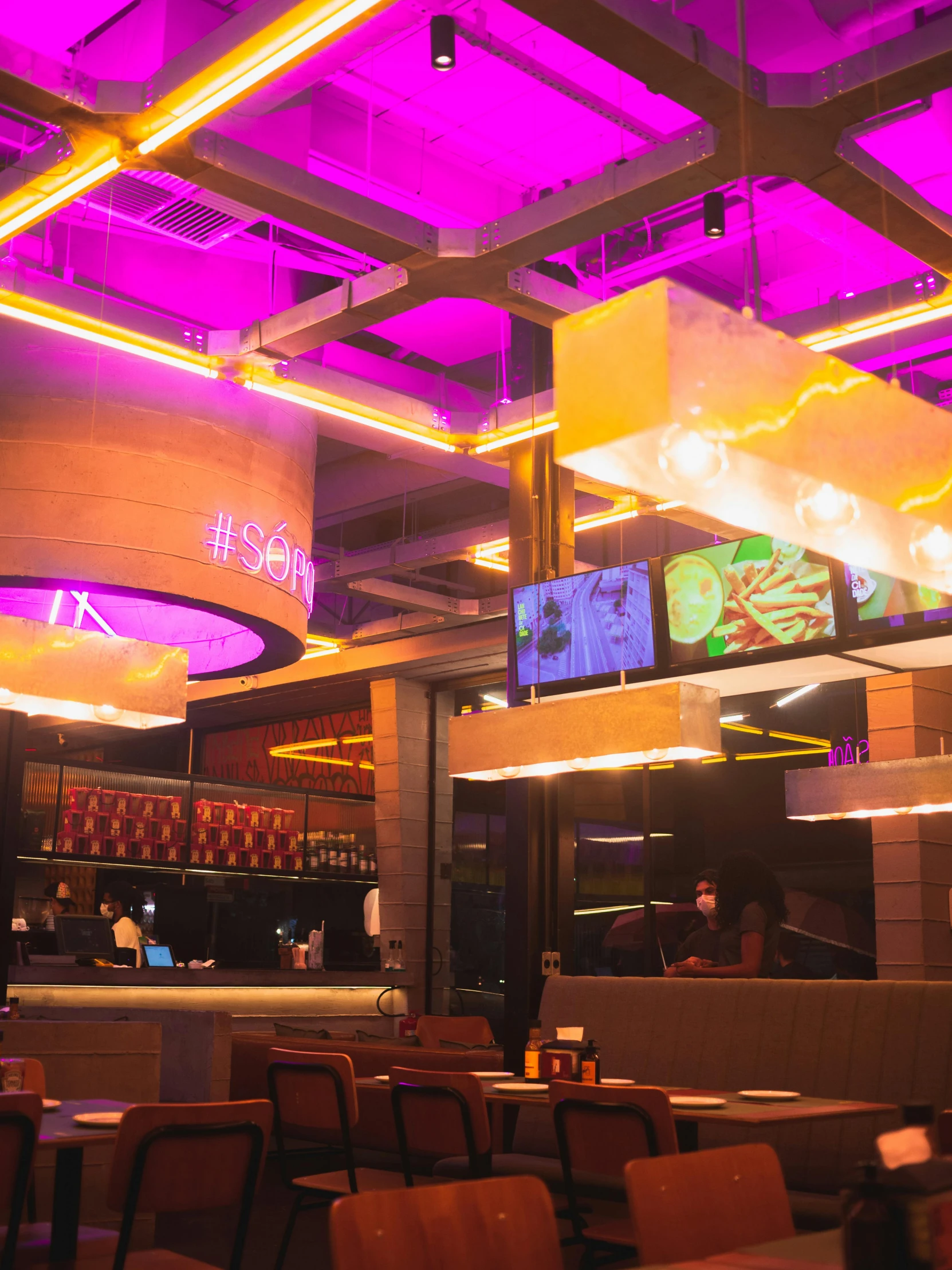 the inside of a restaurant with large purple light