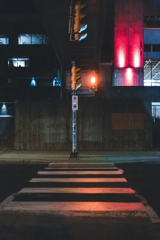 the stop sign is red at night by the street