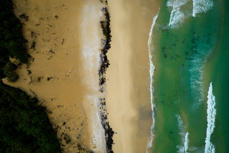 aerial po of shoreline of water and a beach