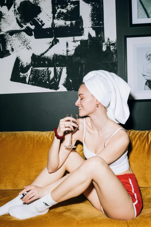 a woman in a towel sitting on top of a couch