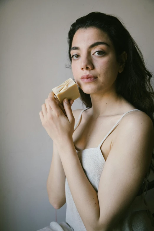 woman posing with short hair and holding a brush