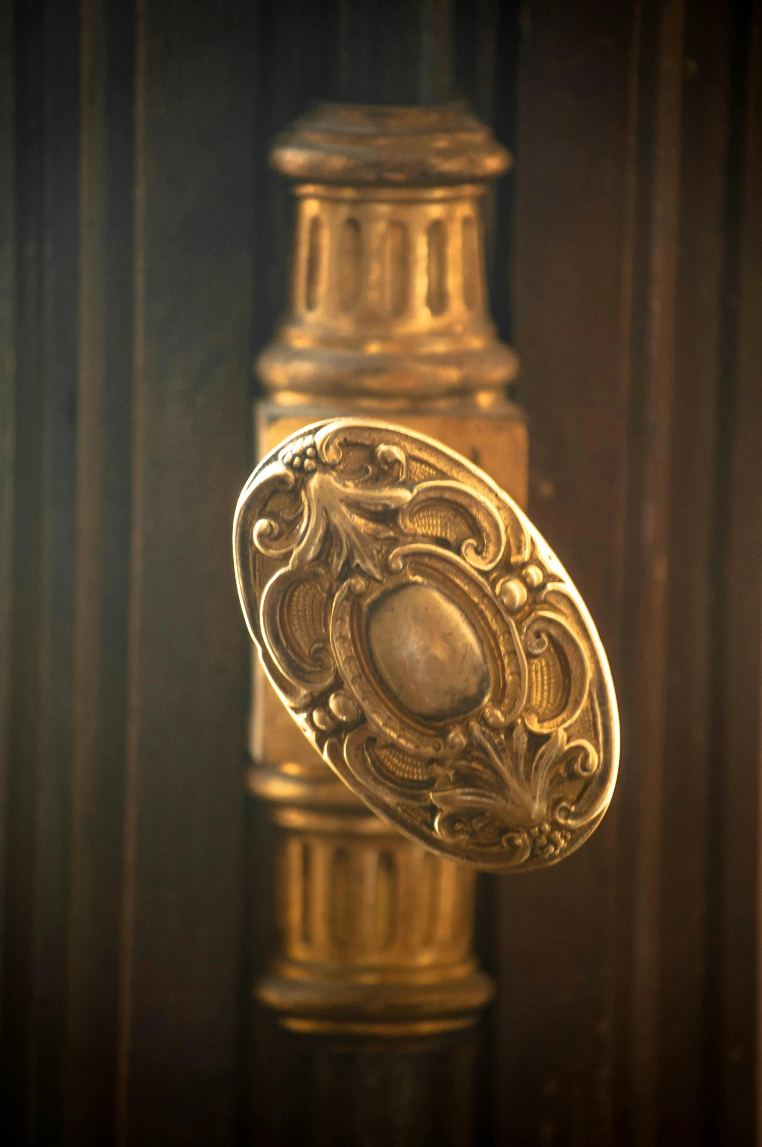 a gold item standing in front of a dark wall