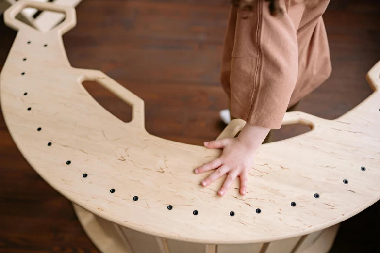 a person standing on top of a wooden chair