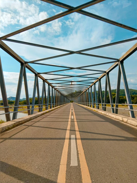 a couple of people are walking across an empty road