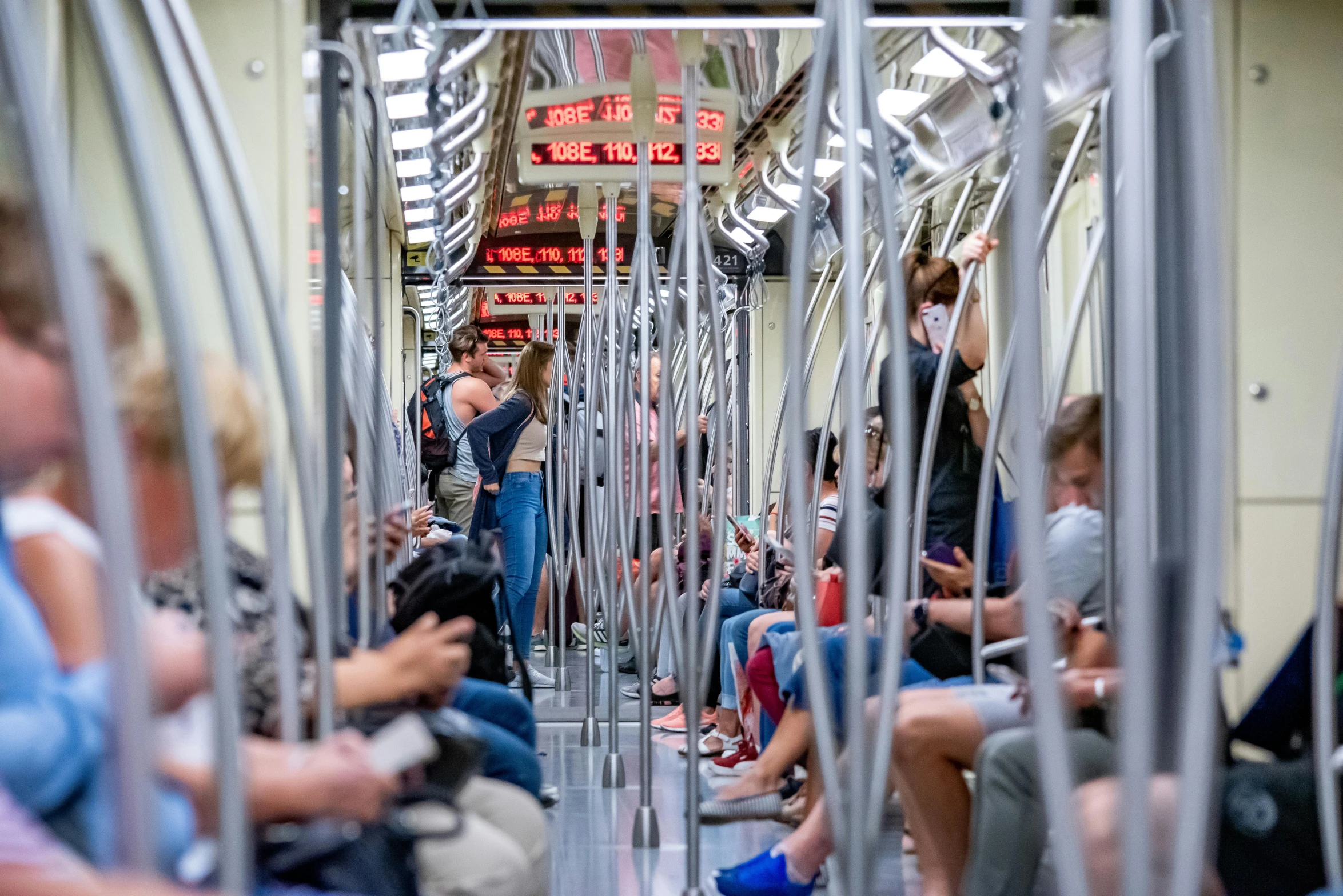 a group of people are riding on a subway