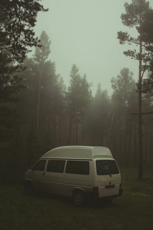 a bus parked in the middle of the woods