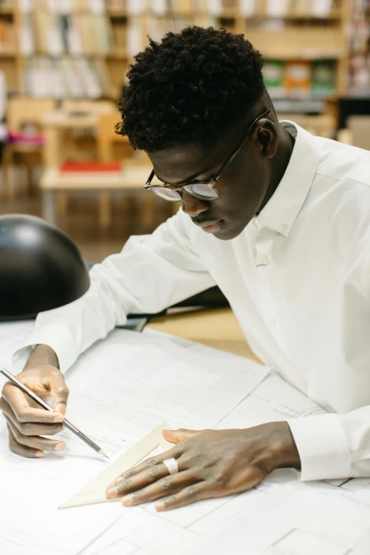 a man writing soing on a piece of paper