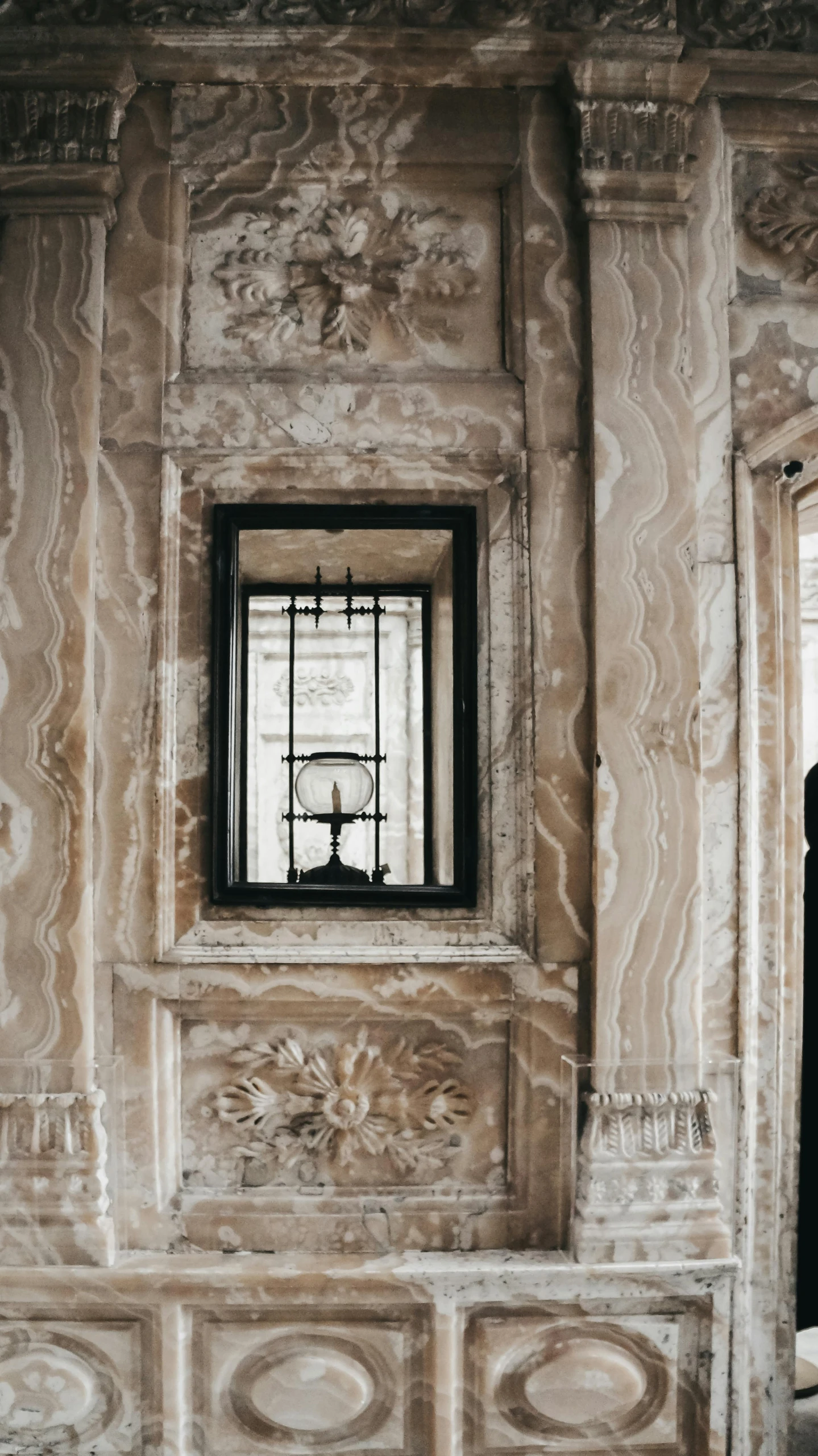 a picture of a room with a small window and curtains