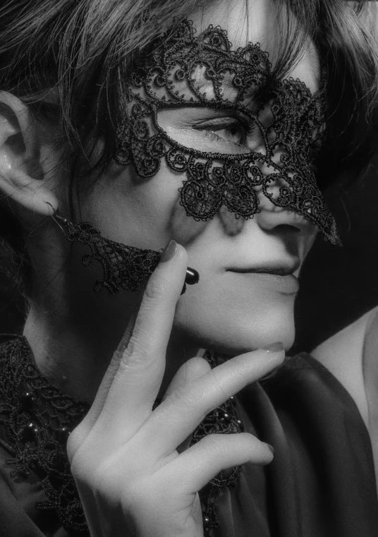 a woman in a masque with jewels on her face