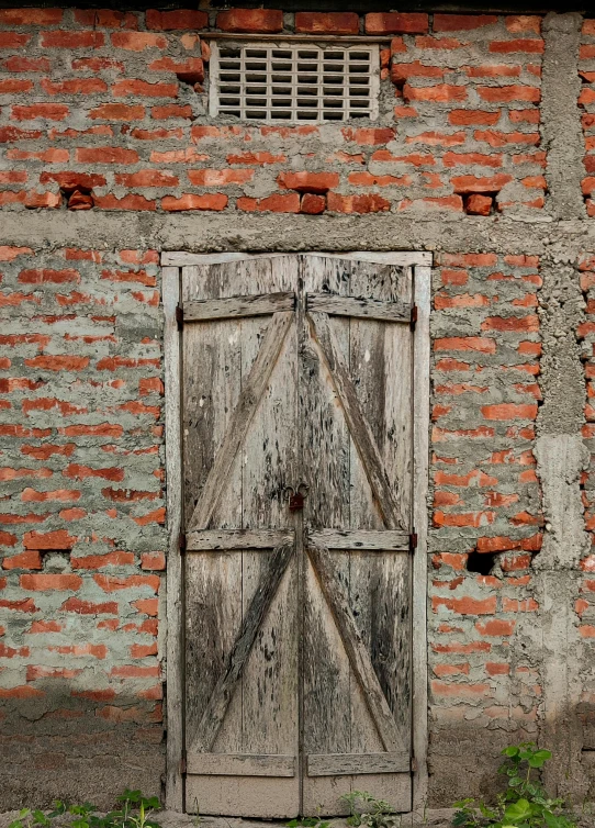 an old, weathered wooden doorway to a brick building