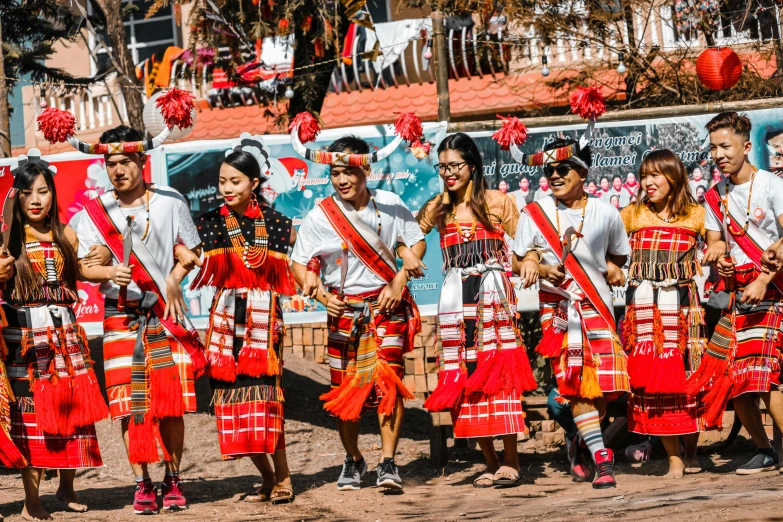 a large group of people in parade clothes standing together