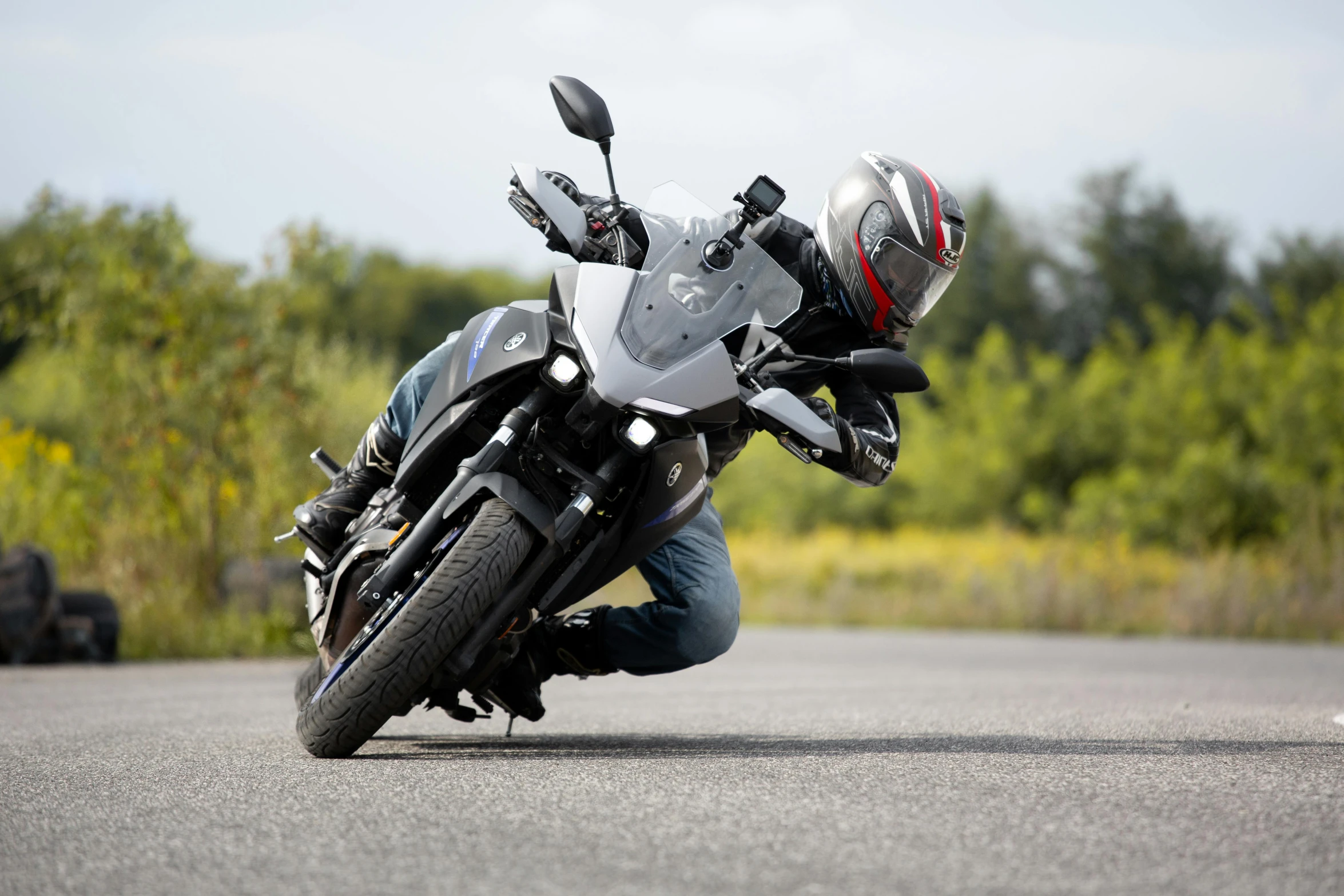 a person leaning over to ride a motorcycle