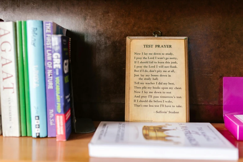 books and a piece of paper sit beside each other on the table