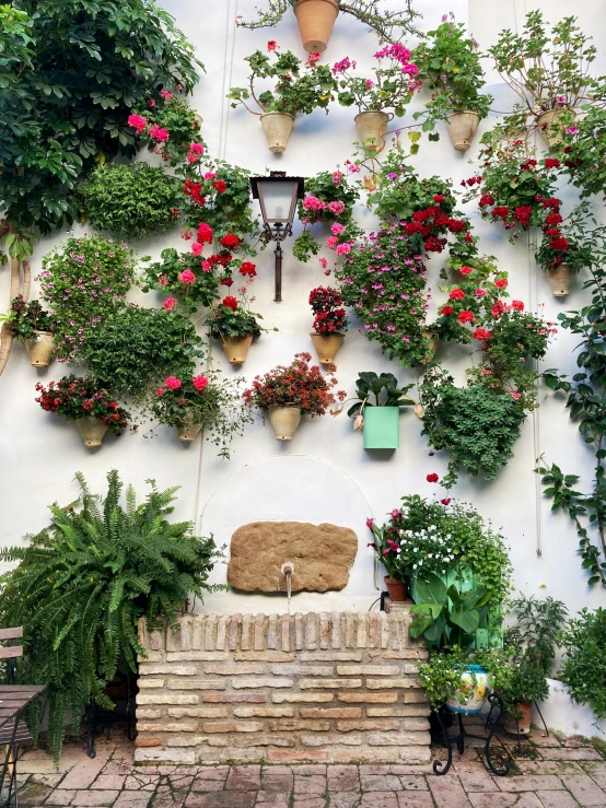 a wall covered in flowers and plant life