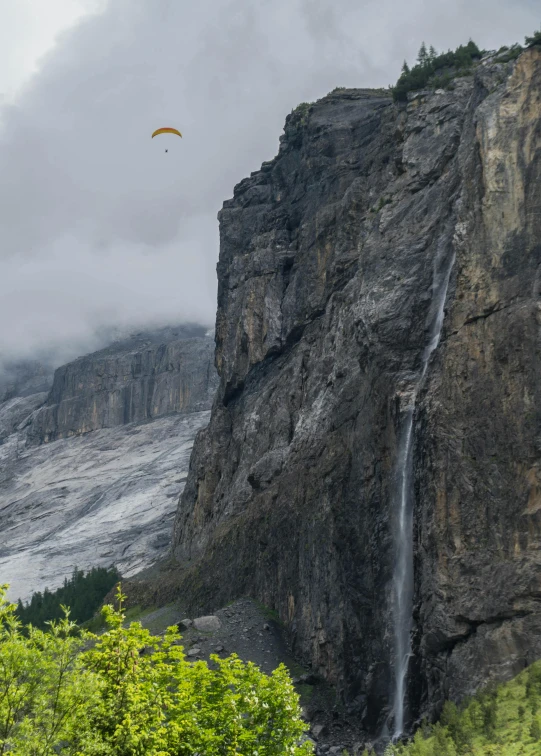 a waterfall and a parachute are near the water