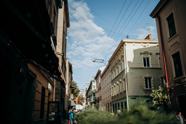 people are standing on a street with power lines above