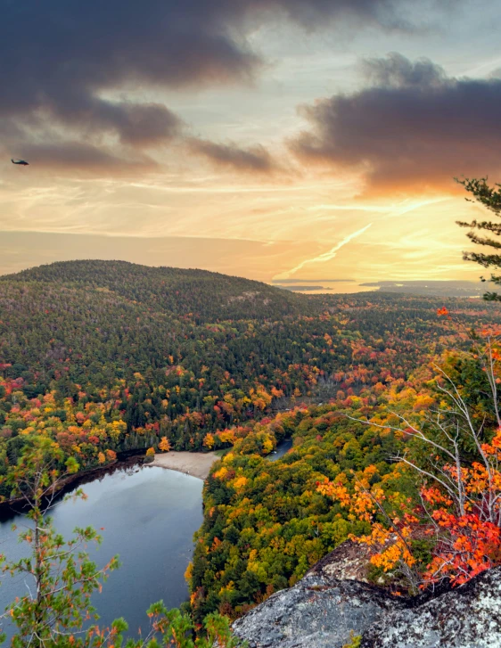 a view of trees, and a lake from a cliff