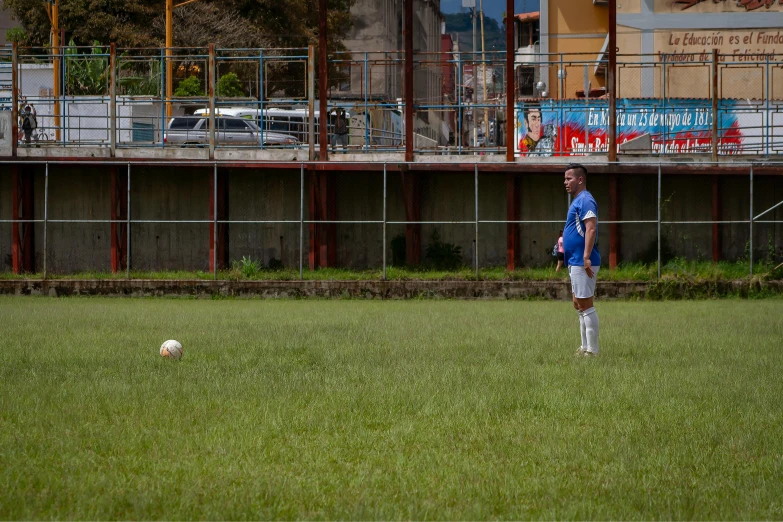 a young man standing on top of a soccer field